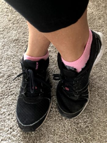 black sneakers and pink socks
