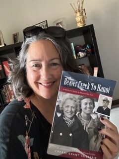 Shelley Burbank smiling and holding book