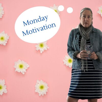 Woman holding a mobile phone and the words "Monday Motivation" in a thought-bubble on a background of daisies.