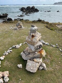 A stack of rocks as a sculpture at the shoreline.